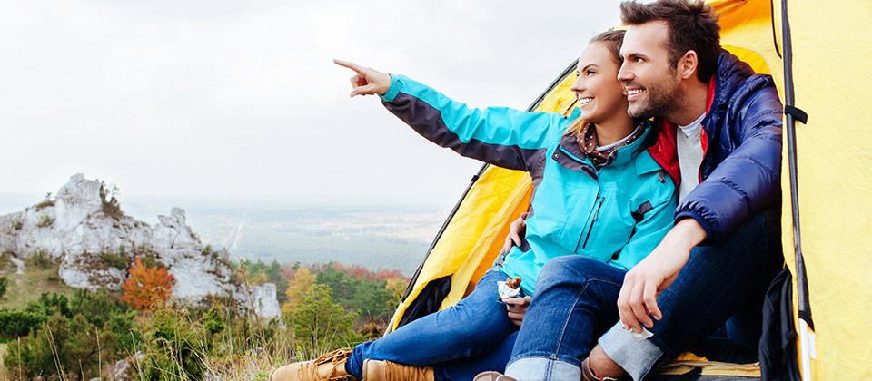 Una coppia in una tenda gialla scruta l'orizzonte