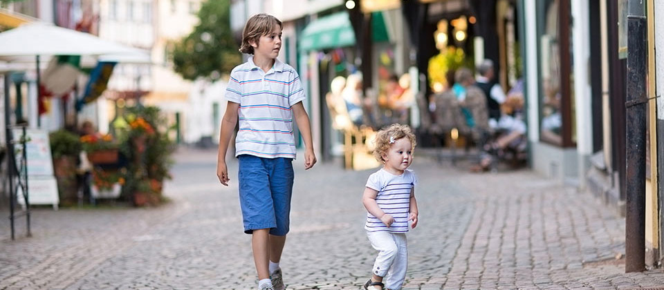 Kids taking a walk in the old town centre of Bolzano