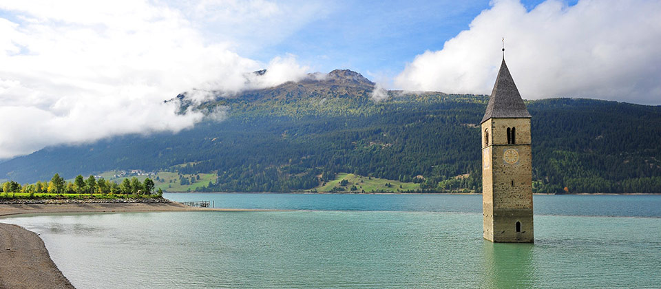 Il campanile semi-sommerso dall'acqua cristallina del lago di Resia